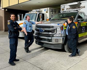 Paramedics standing outside ambulance